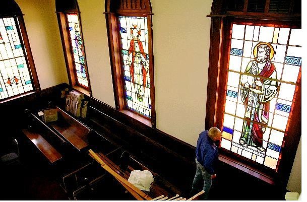 Kevin Clifford/Nevada Appeal Pastor Bruce Kochsmeier on Friday looks at the stained glass windows that will be saved and used in the new First Presbyterian Church if it gets approved.