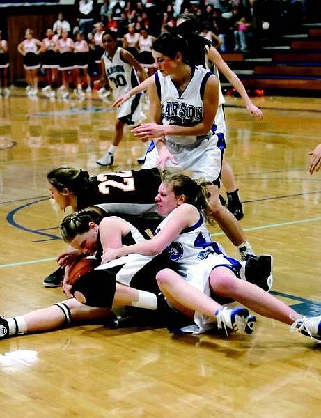 Chad Lundquist/Nevada Appeal #45 Catherine Brekken, wrestle with Douglas forward Jessica Waggner #47 for a loose ball in Tuesdays contest against Carson High.