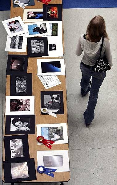 Chad Lundquist/Nevada Appeal An student at walks past the &quot;Reflections&quot; art contest at Carson High School Thursday. There were 61 entries in this years contest Thirty-seven in literature, two in music, four in visual arts and 18 in photography.
