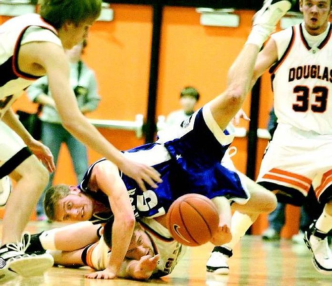 BRAD HORN/Nevada Appeal Carson Senator&#039;s guard Adam Houghton and Douglas Tiger&#039;s center Keith Olson collide while fighting for a loose ball that Houghton stipped during the first half of their game in Minden on Friday.