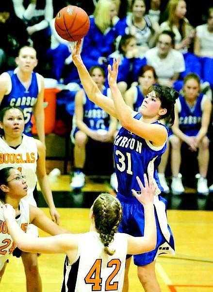 BRAD HORN/Nevada Appeal Carson&#039;s Sinead McSweeney shoots over Douglas Tigers Kristin Wyatt, 24, and Jessica Waggner, 42, during the second half in Minden on Friday.