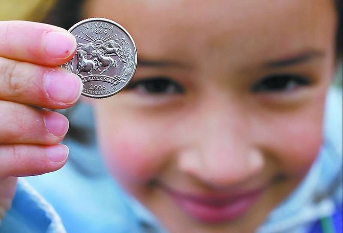 Chad Lundquist/Nevada Appeal Gabriella Vega, 9, a Jack&#039;s Valley Elementary School student, holds up a new Nevada quarter presented to her at the launch ceremony Tuesday morning at the state Capitol. Everyone under 18 received a free quarter for attending the ceremony.