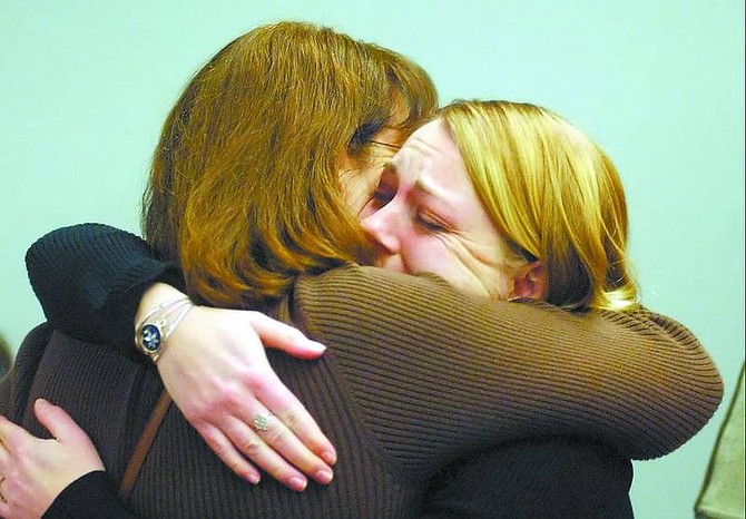BRAD HORN/Nevada Appeal Sarah Koerner hugs her mother, Laura Lau, after receiving a commendation for calling police after she saw the victim of an alleged child abuse case pushing a shopping cart in Carson City.