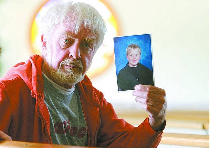 Belinda Grant/Nevada Appeal News Service Don Sullivan holds a photo of his son, David, at St. Gall Catholic Church in Gardnerville recently.
