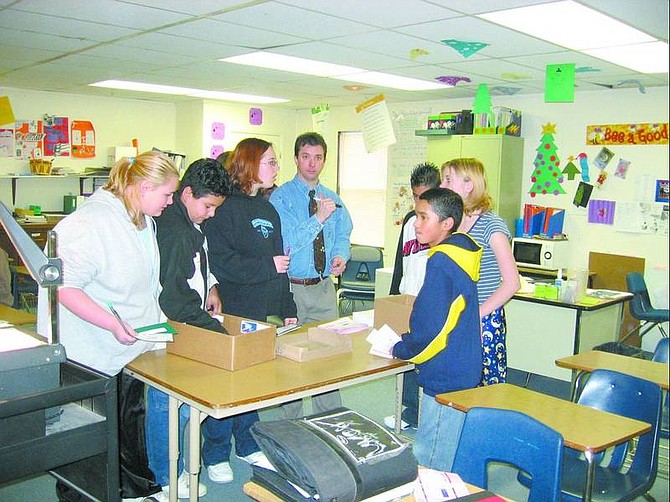 Jenetah Avant/Silver Stage Middle School secretary Silver Stage Middle School students show their understanding of financial responsibility by managing checking accounts. Teacher Paul Sisco is in the center.