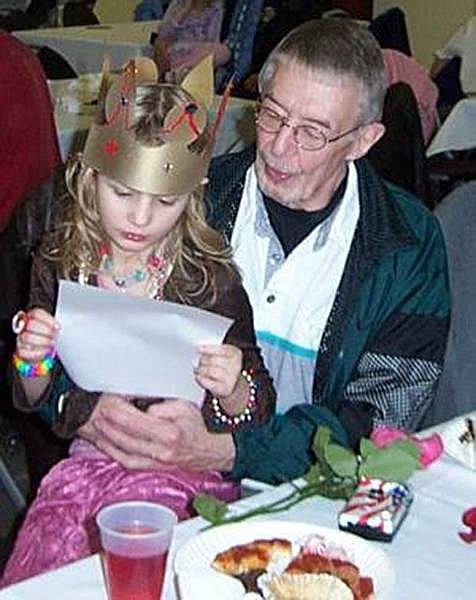 Kasey and John Faur relax at the &quot;Princess and Her Knight&quot; father-daughter dance at Fuji Park. The dance is an annual event of the Girl Scouts.