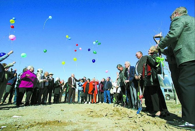 BRAD HORN/Nevada Appeal Lyon County Commissioners and senior center officials watch as seniors release balloons after a groundbreaking ceremony for the $2.17 million Silver Springs Senior Center on Thursday afternoon.