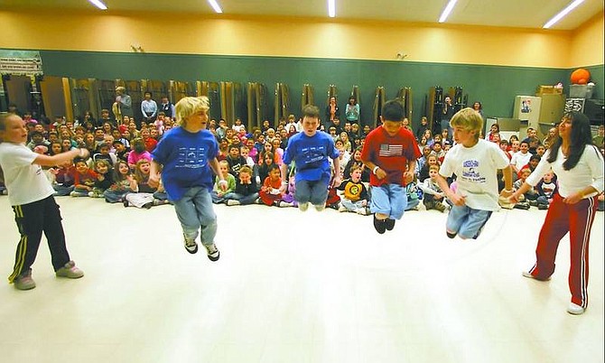 BRAD HORN/Nevada Appeal Nolan Shine, 9, from left, Jusdan Mondragon, 11, Kyle Sharp, 10, and Gehrig Tucker, 10, jump rope at Bordewich-Bray Elementary School on Friday morning during the Jump Rope for Heart fundraiser. First-grade teacher Dona Sharp, right, and Brianna Rotter, 8, left, swing the rope. Below, Sharp performs a couple of jump-rope tricks.