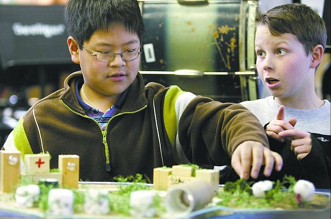 Cathleen Allison/Nevada Appeal Seeliger Elementary School students Andy Shao, 10, and Casey Reid, 11, describe their town, called &quot;Tombolia,&quot; during their gifted-and-talented class last week. The students built future-city projects to learn planning and engineering skills.