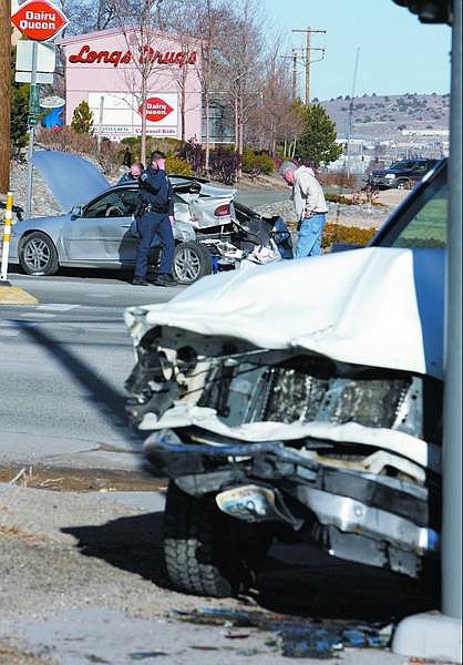 Chad Lundquist/Nevada Appeal Officers from the Nevada Highway Patrol and Carson City Sheriff&#039;s Department investigate the scene of an accident Monday afternoon at the intersection of Highway 50 and Airport Road. A 20-year-old woman from Gardnerville died on the way to the hospital. The second driver was seriously injured.