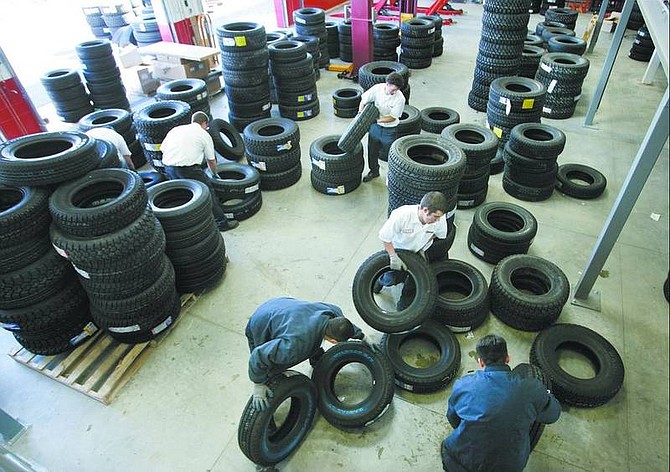 Cathleen Allison/Nevada Appeal A group of employees sorts tires at the new 30,000-square-foot Les Schwab store in North Carson City on Tuesday afternoon in preparation for their opening today.
