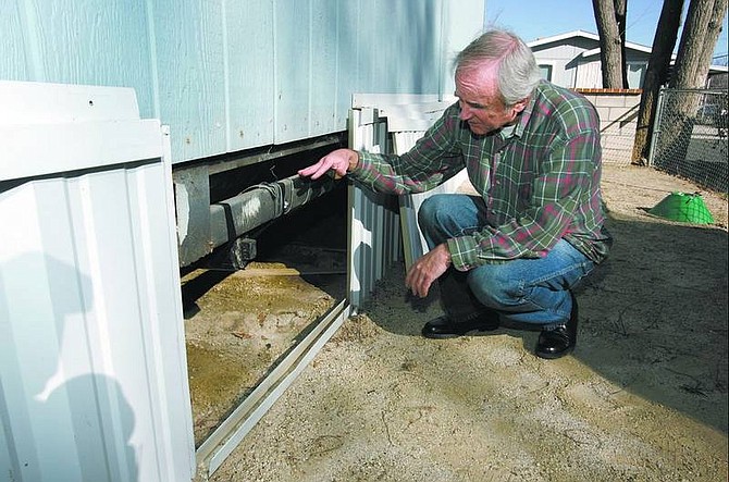Danny  Trowbridge shows the area under his mobile home, in the  Silver State Mobile Home Park, that is damaged by raw sewage.  Trowbridge claims that the damage is a result of the park&#039;s outdated pipe system.  Cathleen Allison/  Nevada Appeal