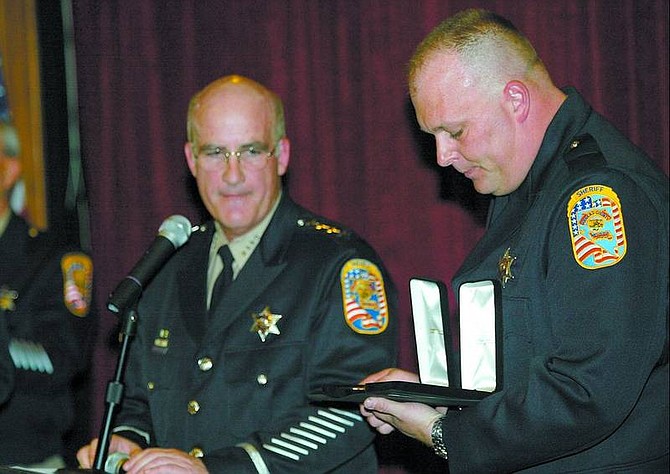 Shannon Litz/The R-C Sheriff Ron Pierini and Deputy Erik Eissinger are shown during the ceremony at Carson Valley Inn Monday. Eissinger and Deputy Dan Nelson received the Purple Heart and Medal of Valor.