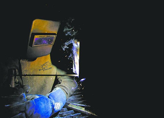 Joe Brillhart, a 17-year-old senior at Carson High School, demonstrates shielded- metal arc welding after finishing competing in the welding competition on Saturday at Western Nevada Community College.  BRAD HORN/ Nevada Appeal