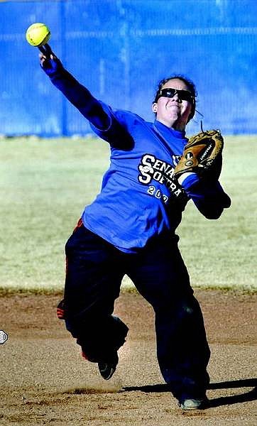 Kurt Molnar/Nevada Appeal After fielding a ground ball, Dacey Hassey, age 16, a junior at Carson High School, throws from second to first base in a pre-season drill during Mondays&#039; team practice.