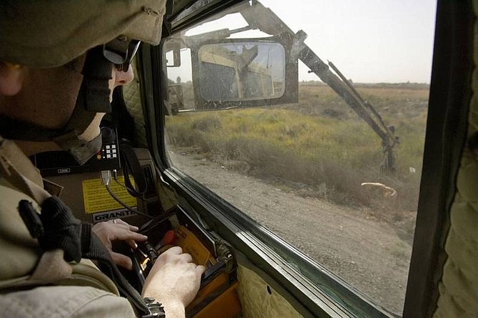 Jacob Silberberg/Associated Press U.S. Army Sgt. Dave Weyant, of Wichita, Kan., sits inside a Buffalo vehicle and uses a robotic arm to search a suspicious piece of refuse for a roadside bomb, called an IED, near Balad, 50 miles north of Baghdad, Iraq, Nov. 5. The United States is pouring billions more dollars and fresh platoons of experts into its campaign to &quot;defeat IEDs.&quot; But out on those risky roads, and back at the Pentagon, few believe that even the most advanced technology will eliminate the threat.