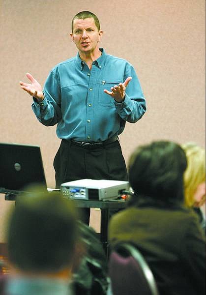 Eric Johnson, director of the Oregon Forensic Institute, talks to a group of school and law enforcement officials about youth violence, Tuesday afternoon at the Pi&#241;on Plaza.  Cathleen Allison/ Nevada Appeal