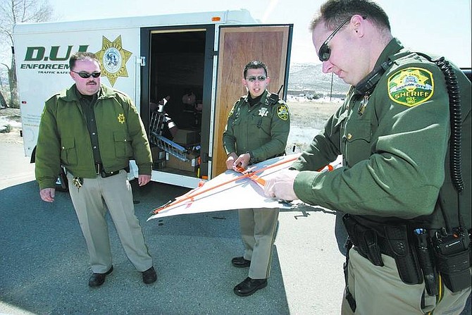 Cathleen Allison/Nevada Appeal Carson City Sheriff&#039;s deputies, from left, Jarrod Adams, Daniel Gonzales and Glenn Fair check out some of the equipment in their new DUI and traffic enforcement trailer on Wednesday morning.