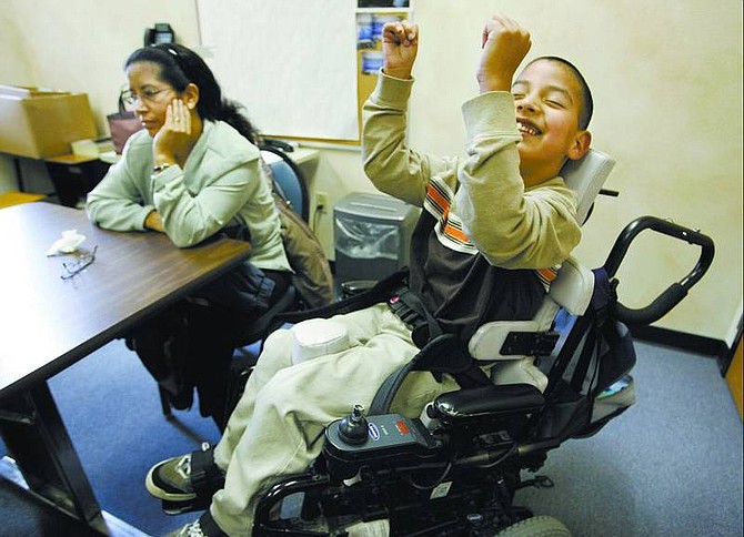 Cathleen Allison/Nevada Appeal Jesse Rojas, 9, who has cerebral palsy, and his mother, Consuelo, talk Wednesday afternoon at Fremont Elementary School. Though Jesse is a typical 9-year-old who finds joy in most everything, his mother is tasked with facing the reality of his situation and is asking the community for help in purchasing a wheelchair-accessible van.