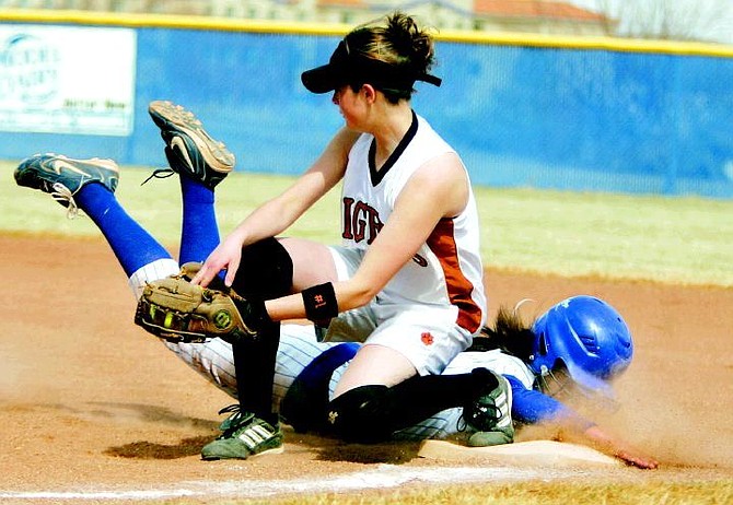 BRAD HORN/Nevada Appeal Carson&#039;s Christa Casci gets tagged out on a pickoff play by Douglas first baseman Michelle Nenzel on Friday.