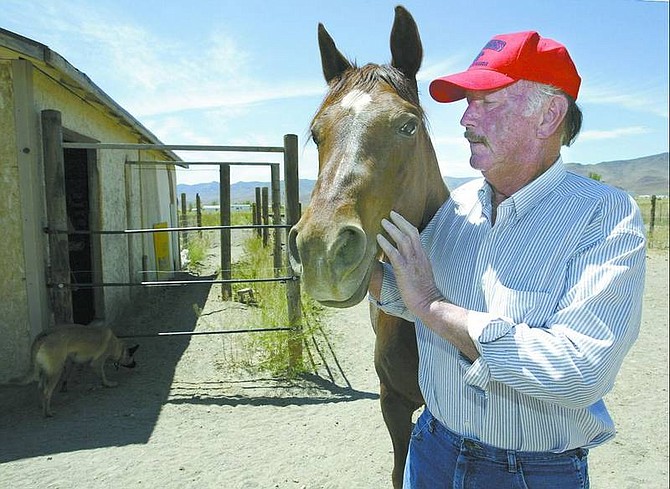 Cathleen Allison/Nevada Appeal File Photo Larry McPherson talks to his horse, Sundown, at his Stagecoach ranch. McPherson is president of the Nevada Division of the National Pony Express Association.