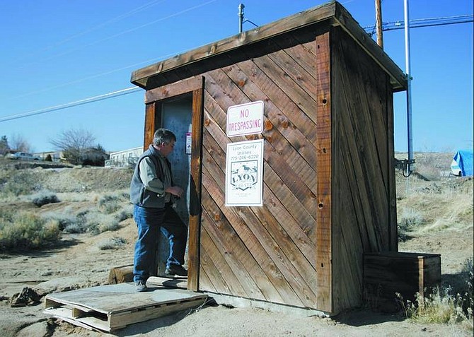 Lyon County Utilities Director Mike Workman enters a shed containing the Rose Peak No. 2 well head in February. This well dates back to the 1970s and produces 90 gallons of water per minute. It is on a list of wells to be replaced, which will be paid for out of operating funds, paid by  ratepayers rather than  connection fees.  photos by  Chad Lundquist/ Nevada Appeal