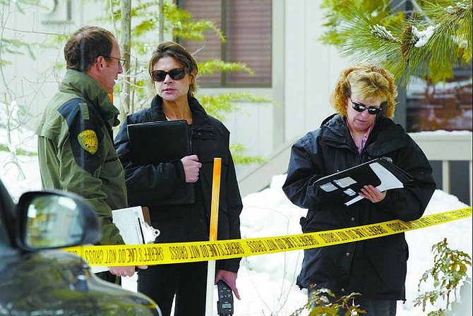 Emma Garrard/Nevada Appeal News Service Sgt. Bill Devine talks to Washoe County crime scene investigators after a woman was found dead outside the apartments in Incline Village on Tuesday morning. Devine was the first officer on the scene.