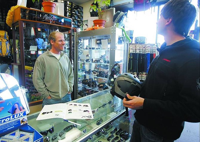 Chad Lundquist/Nevada Appeal David Goodwin, left, co-owner of The Sporting Rage, talks with vendor Mark Mackay in his shop located in south Carson City on Monday. Goodwind says he is happy to hear that the city intends to improve the area&#039;s business climate by expanding the redevelopment zone.