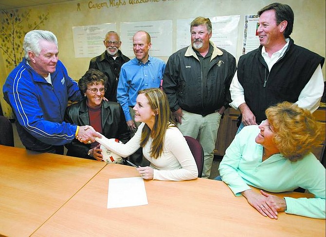 Cathleen Allison/Nevada Appeal Carson High School senior Cassie Bowman gets congratulated by family and coaches Tuesday afternoon at CHS after she signed a letter of intent to play soccer for William Penn University. Clockwise from left, CHS Athletic Director Ron McNutt, grandparents Karen and Bob Bowman, coaches Dennis Brinson, Greg Davis, Randy Roser, mom Kellie Bowman and Cassie.
