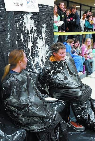 Chad Lundquist/Nevada Appeal Teachers Sarah Piggott, ninth-grade math, and Gary Casselman, ninth-grade science, have pies thrown at them by students during a Stand Tall Don&#039;t Fall Alcohol Awareness event last Friday at Carson High School.