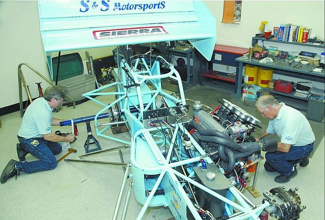 Kevin Clifford/Nevada Appeal Owners of S&amp;S Motorsports, Tom Silsby, left, and Steve Shaw, recently do some work on their supermodified race car in Carson City.