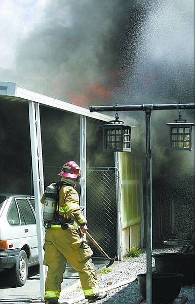 Cathleen Allison/Nevada Appeal Carson City firefighters extinguished a fire in the Carson Tahoe Mobile Home Park on Wednesday.