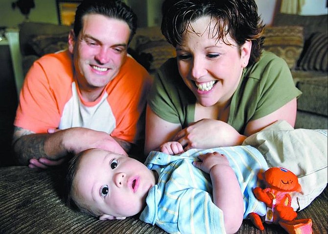Terry and Catherine Benson play with their 5-month-old son Zachary Tuesday after learning that his critically needed surgery will be covered by insurance.   Chad Lundquist/ Nevada Appeal
