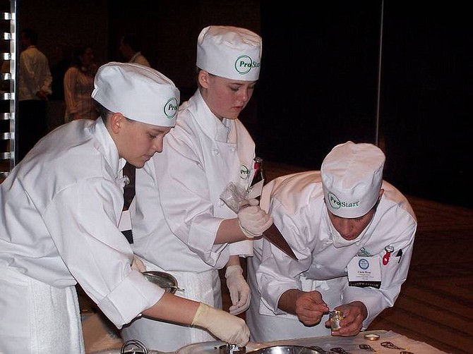 Penny Reynolds/For the Nevada Appeal Rachel Neitzke, Kelly Taylor and Chris Wear, all culinary students from Carson High School, work on a chocolate butterfly to top their dessert at the national ProStart competition Monday in Charlotte, N.C. The team placed in the top 10.