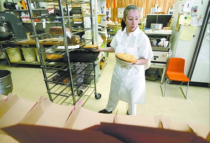 Cathleen Allison/Nevada Appeal Sierra Bakery owner Elvira Diaz boxes pies Thursday morning at her East Carson City business. She is opposed to proposed legislation that would make it a crime to help illegal immigrants. She says the 12 million illegal immigrants estimated to be living in the country should to be put on a path to legalization.