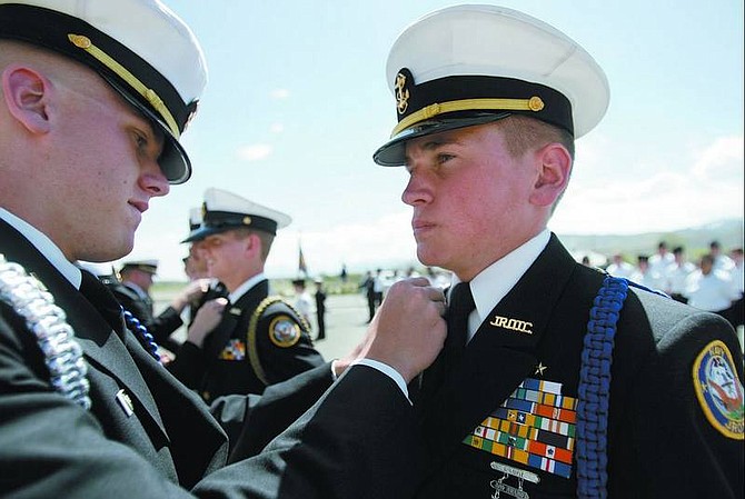 Carson High senior Cody Stokes, 17, left, passes his rank on to Andrew Stephenson, 17, who will take his place as battallion executive officer in the 2006-07 school year.