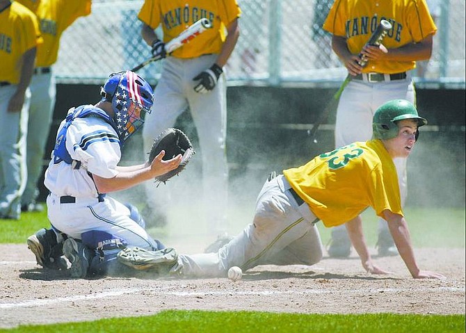 Cathleen Allison/Nevada Appeal Manogue runner Timothy Lewis knocks the ball loose from  Carson&#039;s catcher Brooks Greenlee in the sixth inning of Tuesday&#039;s game at Manogue.