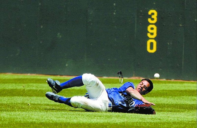 BRAD HORN/Nevada Appeal Carson High School center fielder Royal Good dives for a ball during the fourth inning of their game agianst Damonte Ranch on Wednesday.