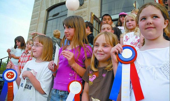 From right, third-graders Morgan Claypool, Brooke Scott, Alexis Conley and second-grader Jessica Matthews stand in front of the Dayton courthouse on Friday evening after placing in the Dayton Justice Court fifth annual art contest.   Kevin Clifford Nevada Appeal
