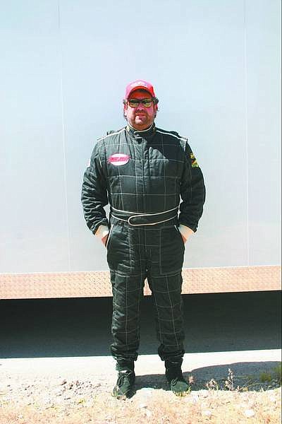 Submitted photo Carson City accountant Brian Colodny stands in his speedtruck racing gear.