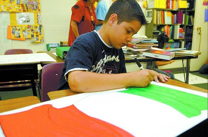 Shannon Litz/Nevada Appeal News Service Carson Valley Middle School seventh-grader Luis Torres colors a Mexican flag for the multicultural festival. BELOW:From left, Piper Vega, Toni Anzelong, Yoli Hamzik, Tito Hoelzen and Felipe Troutner are in the Spanish II class at Carson Valley Middle School. They will put on various demonstrations for the festival.