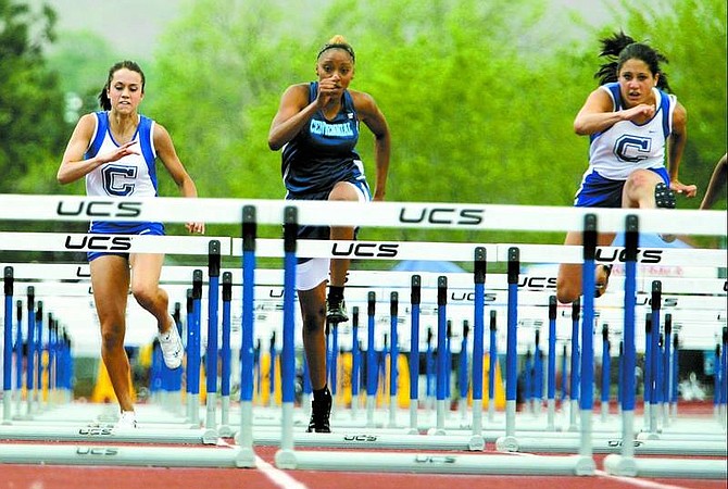 BRAD HORN/Nevada Appeal Carson&#039;s Kayla Sanchez, left, and Andrea K. , right, compete in the 110 meter high hurdles during the NIAA Nevada State Track and Field Championships at Reno High School on Friday.