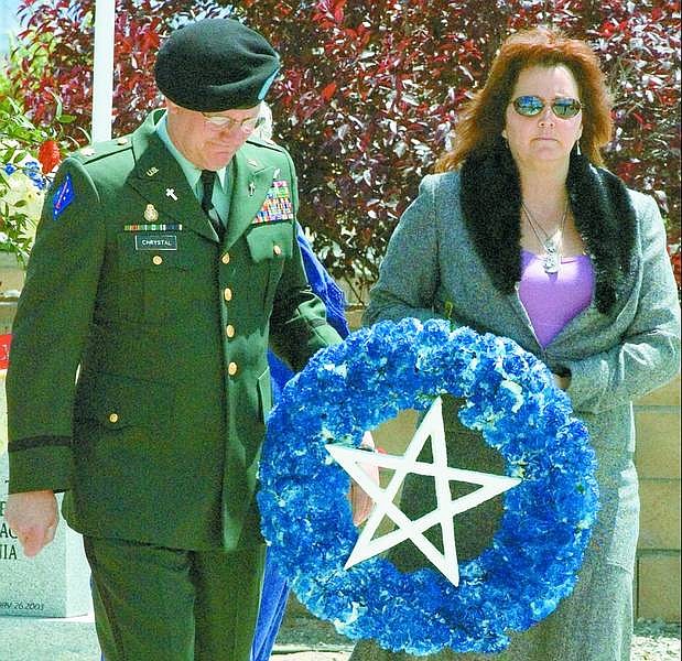 Kim Lamb/Nevada Appeal News Service At the Northern Nevada Veterans Memorial Cemetery in Fernley Monday, Chaplain Bill Chrystal, left, and Roberta Stewart carry the Wiccan symbol of the pentacle in honor of Sgt. Patrick Stewart, a Nevada National Guardsman who was killed in Afghanistan in September. The Department of Veterans Affairs would not allow the pentangle on her husband&#039;s memorial plaque.