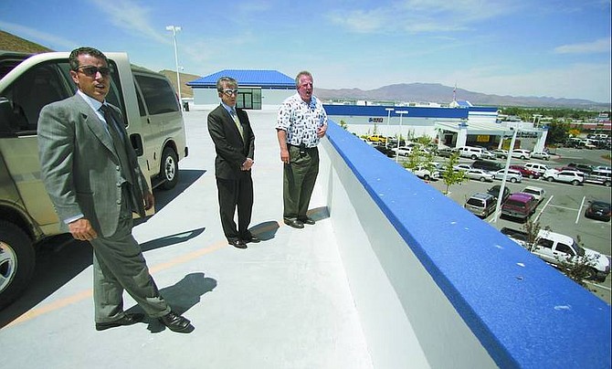 BRAD HORN/Nevada Appeal Attorneys John W. Griffin, left, and Bob Crowell and Casino Fandango General Manager Steve Forester, right, talk about the casino&#039;s expansion from the top of the parking garage on Wednesday.