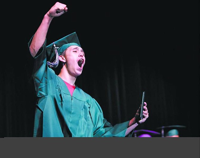 Chad Lundquist/Nevada Appeal Pioneer High School graduate Josh Moore, 18, gives a well deserved cheer after receiving his diploma on Tuesday night at the Carson City Community Center.