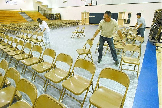 Cathleen Allison/Nevada Appeal From left, Sheryl Brown, Dave Hodgen and Randy Valiska set up for the Silver Stage High School graduation ceremony Wednesday afternoon. Sixty-five students will graduate in the ceremony, at 6:30 tonight.