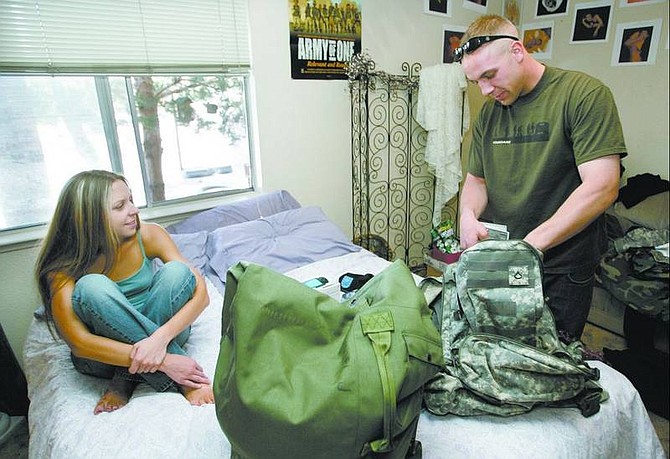 Carson&#039;s Justin Krodel, 25, packs up to deploy to Germany on Thursday morning as his girlfriend Christina Keith watches.    Cathleen Allison/ Nevada Appeal