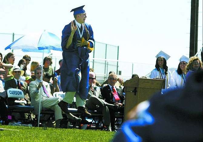 BRAD HORN/Nevada Appeal Carson High School graduate Mitchell Grover celebrates before receiving his diploma at the Carson High School commencement ceremonies on the football field Saturday morning. Mitchell plans to attend the University of Nevada, Reno in the fall.