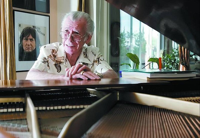 Chad Lundquist/Nevada Appeal Richard Sowers, 76, sits at his baby grand piano at his Carson City home.