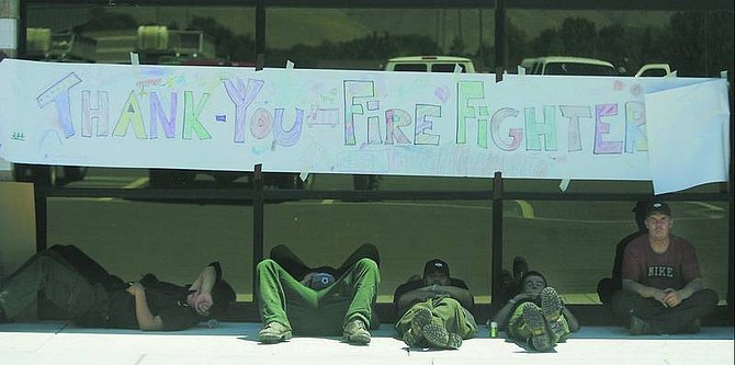 Brad Horn/Nevada Appeal Firefighters from the Northern Native Rocky Mountain Firefighters, of Browning, Mont., the Blackfeet Reservation, rest after fighting the Linehan fire in Mound House on Thursday at base camp at Carson High School in Carson City.